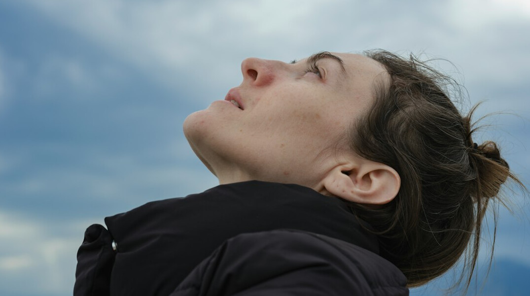 Woman relaxing and breathing calmly outdoors